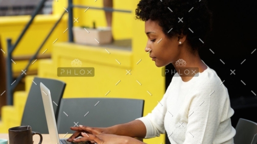demo-attachment-1082-attractive-young-woman-using-laptop-outside-P9RLFGU@2x