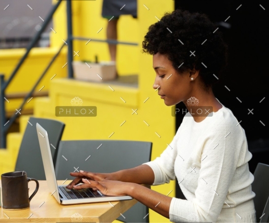 demo-attachment-1082-attractive-young-woman-using-laptop-outside-P9RLFGU@2x